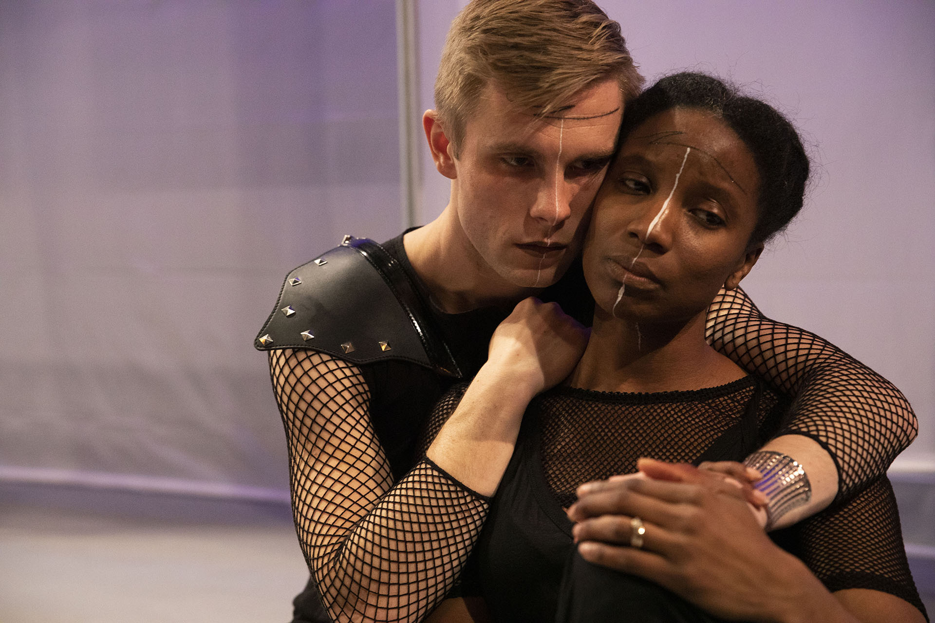 two actors, a white man and a Black woman, embracing